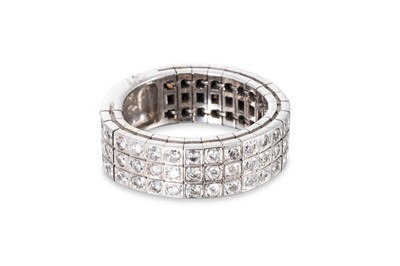Lot 104 - A THREE ROWED DIAMOND RING, of flexible form,...