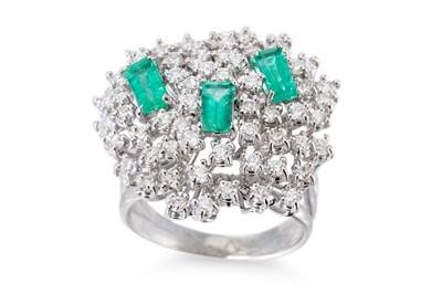Lot 214 - AN EMERALD AND DIAMOND CLUSTER RING, the three...