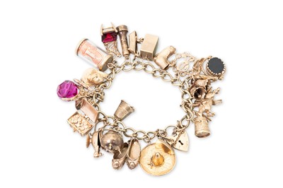 Lot 346 - A VINTAGE 9CT GOLD CHARM BRACELET, with...
