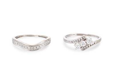 Lot 235 - A DIAMOND SET BAND RING, of curved form,...