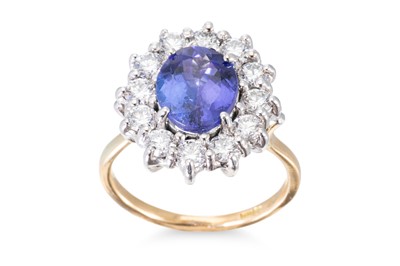 Lot 114 - A TANZANITE AND DIAMOND CLUSTER RING, mounted...