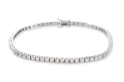 Lot 174 - A DIAMOND LINE BRACELET, the round brilliant...