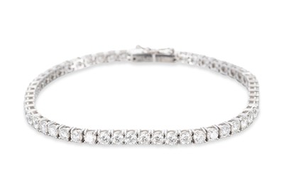Lot 285 - A DIAMOND LINE BRACELET, the round brilliant...