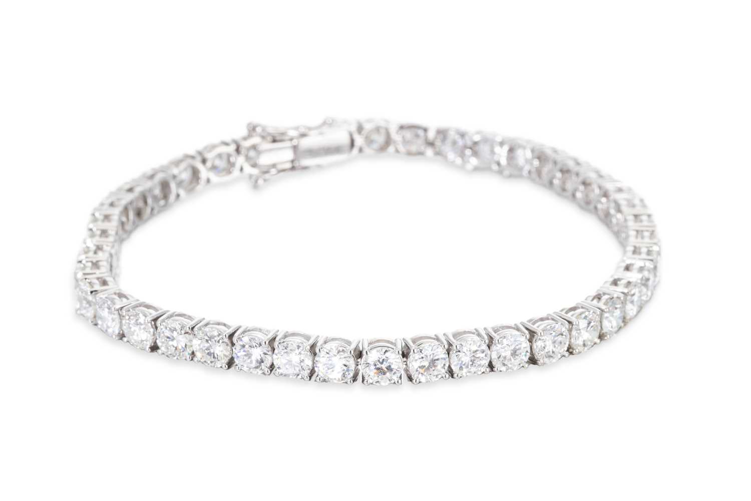 Lot 326 - A DIAMOND LINE BRACELET, the round brilliant...