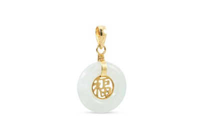 Lot 35 - A JADE PENDANT, the cabuchon donut shaped jade...
