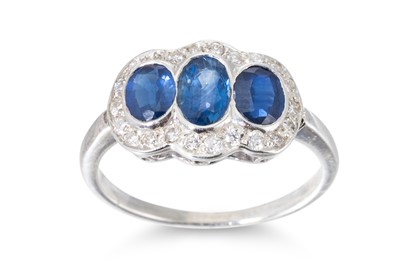 Lot 39 - A DIAMOND AND SAPPHIRE THREE STONE RING, the...