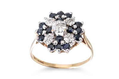Lot 132 - A DIAMOND AND SAPPHIRE CLUSTER RING, the round...