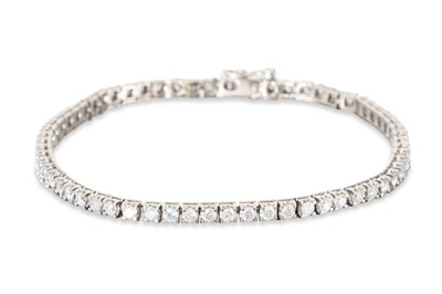 Lot 309 - A DIAMOND LINE BRACELET, the brilliant cut...