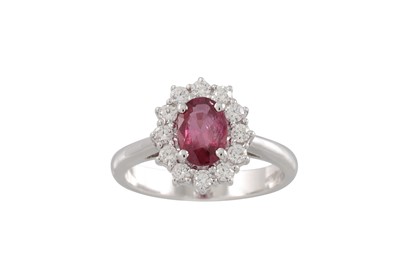 Lot 187 - A DIAMOND AND RUBY CLUSTER RING, the oval ruby...