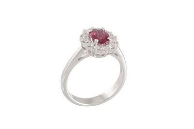 Lot 187 - A DIAMOND AND RUBY CLUSTER RING, the oval ruby...