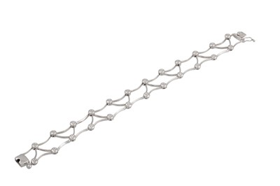 Lot 209 - A DIAMOND SET BRACELET, of openwork design,...