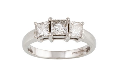 Lot 9 - A DIAMOND THREE STONE RING, set with princess...