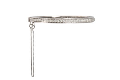 Lot 128 - A DIAMOND SET BANGLE, the brilliant cut...