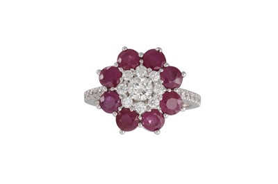 Lot 284 - A RUBY AND DIAMOND CLUSTER RING, daisy form,...