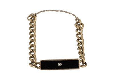 Lot 3 - AN ONYX AND DIAMOND ID BRACELET, mounted in...