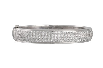 Lot 251 - A DIAMOND SET BANGLE, the brilliant cut...