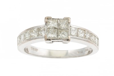 Lot 216 - A DIAMOND CLUSTER RING, the princess cut...