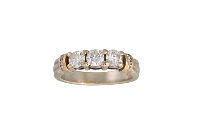 Lot 100 - A THREE STONE DIAMOND RING, the brilliant cut...