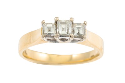 Lot 97 - A THREE STONE DIAMOND RING, the emerald cut...
