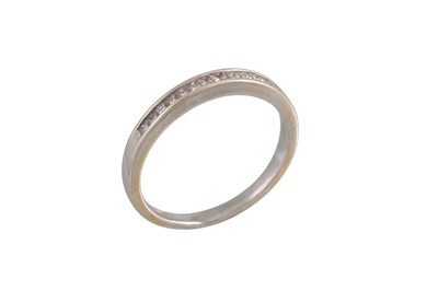 Lot 24 - A DIAMOND HALF ETERNITY RING, channel set with...