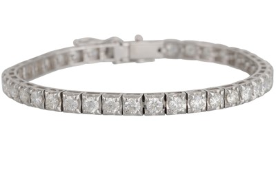 Lot 193 - A DIAMOND LINE BRACELET, the brilliant cut...