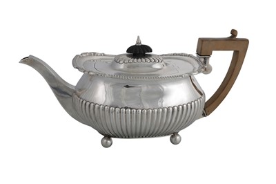 Lot 596 - A VICTORIAN SILVER GADROONED TEA POT, of...