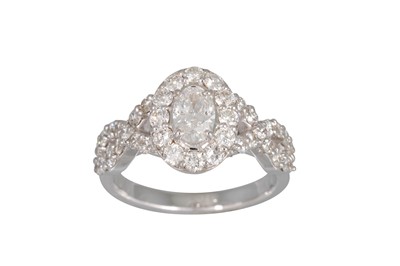 Lot 248 - A DIAMOND CLUSTER RING, the oval brilliant...