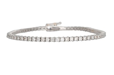 Lot 24 - A DIAMOND LINE BRACELET, the brilliant cut...