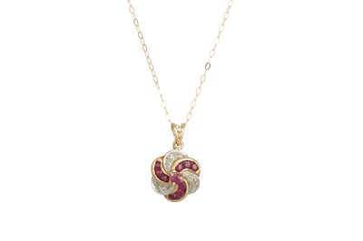 Lot 67 - A RUBY AND DIAMOND PENDANT, of swirl design,...