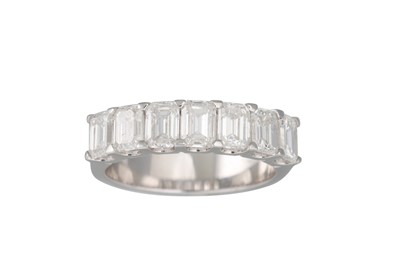 Lot 163 - AN EMERALD CUT DIAMOND HALF ETERNITY RING,...
