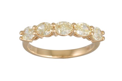 Lot 164 - AN OVAL CUT FANCY YELLOW DIAMOND FIVE STONE...
