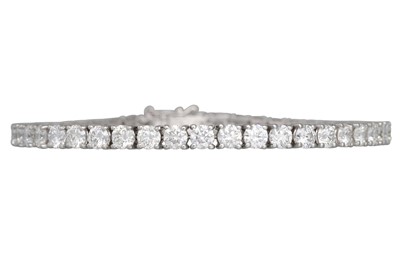 Lot 229 - A DIAMOND LINE BRACELET, the brilliant cut...