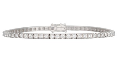 Lot 239 - A DIAMOND LINE BRACELET, the brilliant cut...