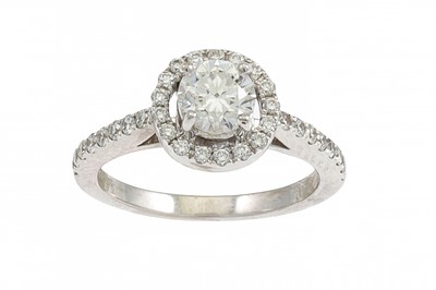 Lot 155 - A DIAMOND 'HALO' CLUSTER RING, the brilliant...