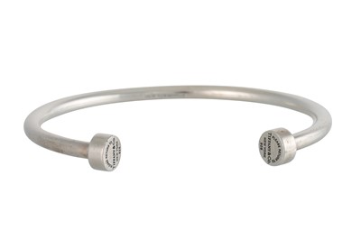 Lot 343 - A SILVER TIFFANY & CO. BANGLE, open design,...