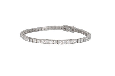 Lot 202 - A DIAMOND LINE BRACELET, the brilliant cut...