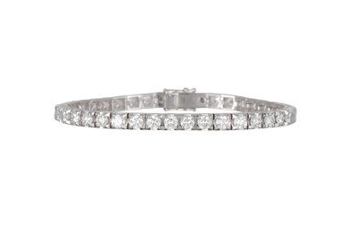 Lot 203 - A DIAMOND LINE BRACELET, the brilliant cut...
