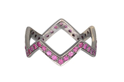 Lot 214 - A RUBY SHAPED BAND RING, in zig-zag form,...