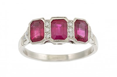 Lot 356 - A RUBY AND DIAMOND RING, set with three trap...
