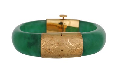 Lot 37 - A  CARVED JADE BANGLE, gold mounts with...