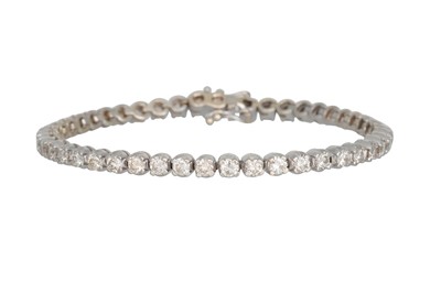 Lot 79 - A DIAMOND LINE BRACELET, the brilliant cut...