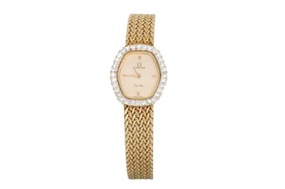 Lot 99 - A LADY'S OMEGA WRIST WATCH, gilt dial, diamond...