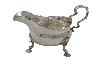 Lot 610 - A GEORGIAN STYLE SILVER HELMET SHAPED SAUCE...