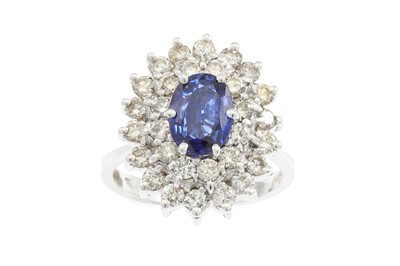 Lot 286 - A SAPPHIRE AND DIAMOND CLUSTER RING, the oval...