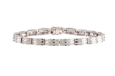 Lot 287 - A DIAMOND BRACELET, each link channel set with...