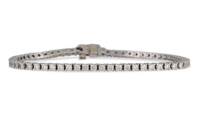 Lot 56 - A DIAMOND LINE BRACELET, the brilliant cut...