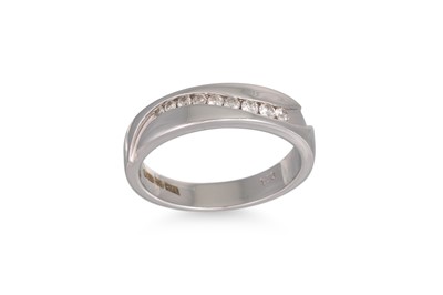 Lot 213 - A CHANNEL SET DIAMOND RING, mounted in 9ct...