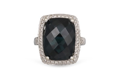 Lot 23 - A TOPAZ AND DIAMOND CLUSTER RING, the blue...
