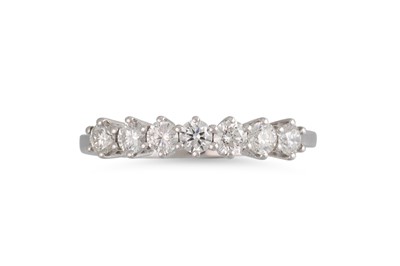 Lot 186 - A SEVEN STONE DIAMOND RING, the brilliant cut...