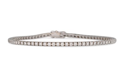 Lot 232 - A DIAMOND LINE BRACELET, the brilliant cut...